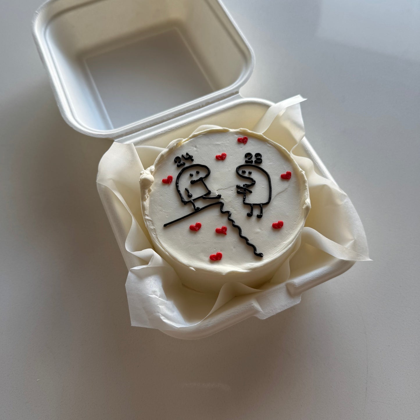 bento cake with stick figure drawings