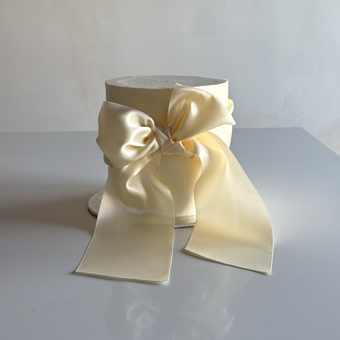 single tier wedding cake with thick satin bow and minimal design for a wedding in Montreal