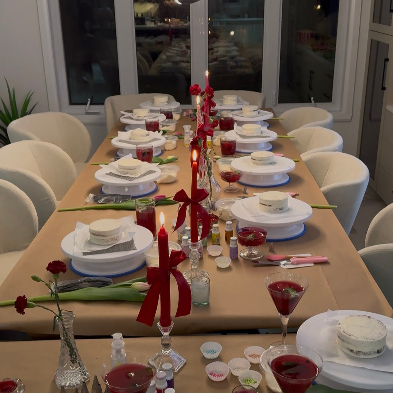 Table set up with turntables, cakes, drinks, supplies, decor for a private cake decorating class in Montreal