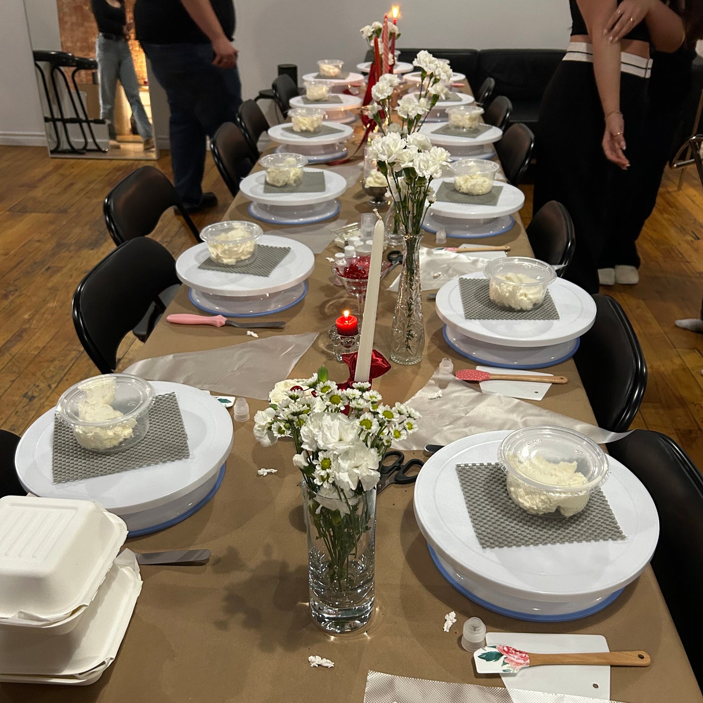 Table set up with turntables, cakes, supplies and decor for a cake & sip event in Montreal