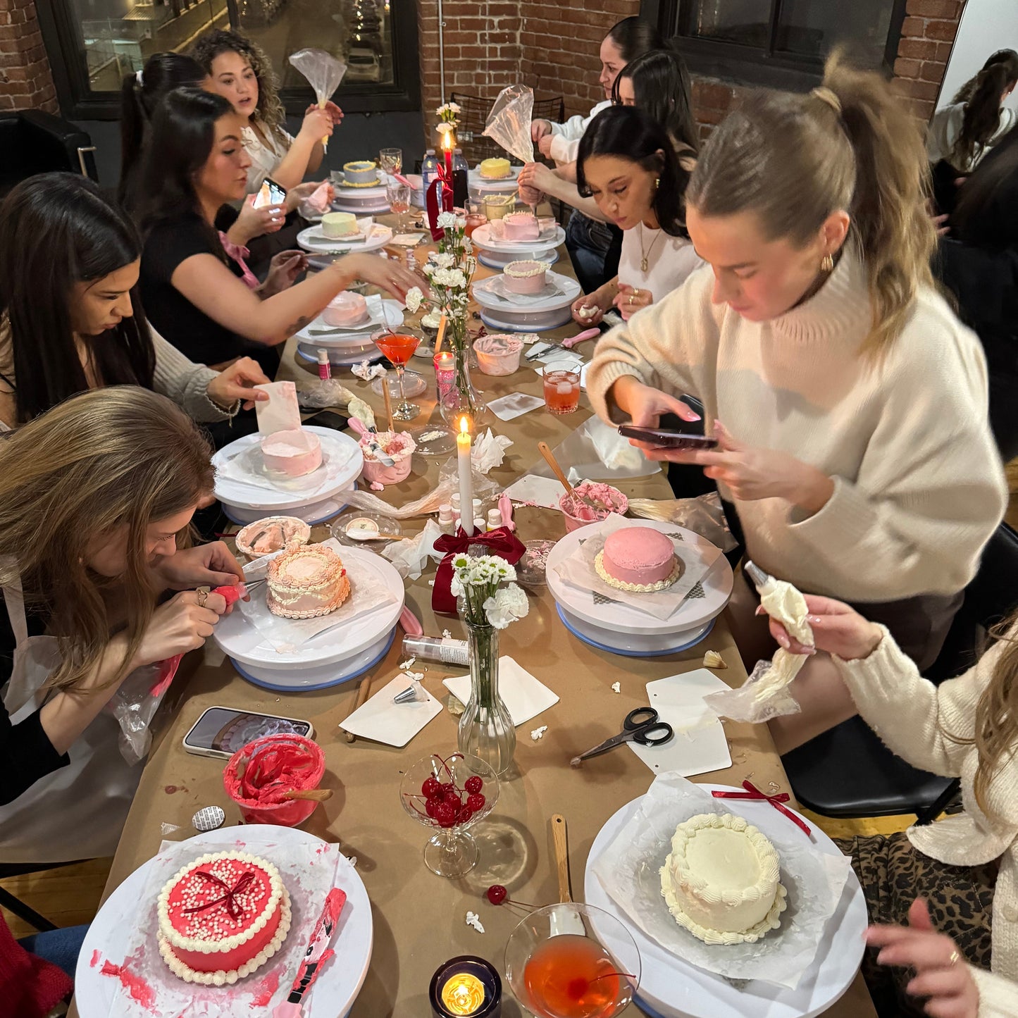 Close-up of guests piping onto a bento cake during a cake & sip event in Montreal