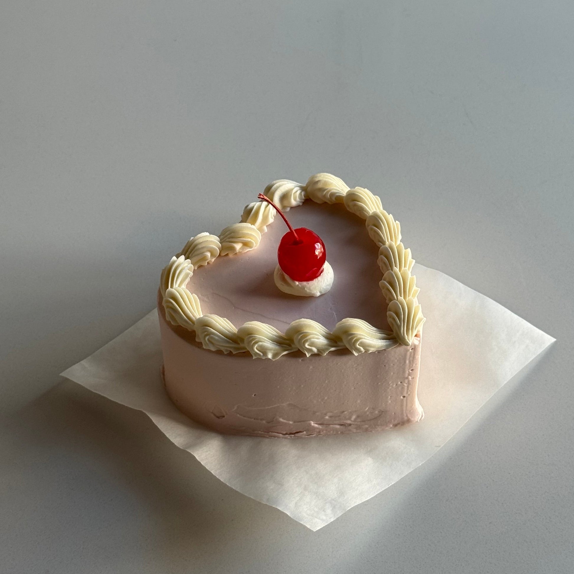 pink heart shape vintage bento cake with a cherry on top