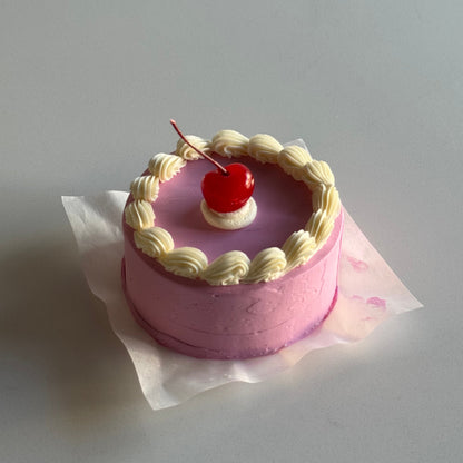 candy pink vintage bento cake with a white border and cherry on top