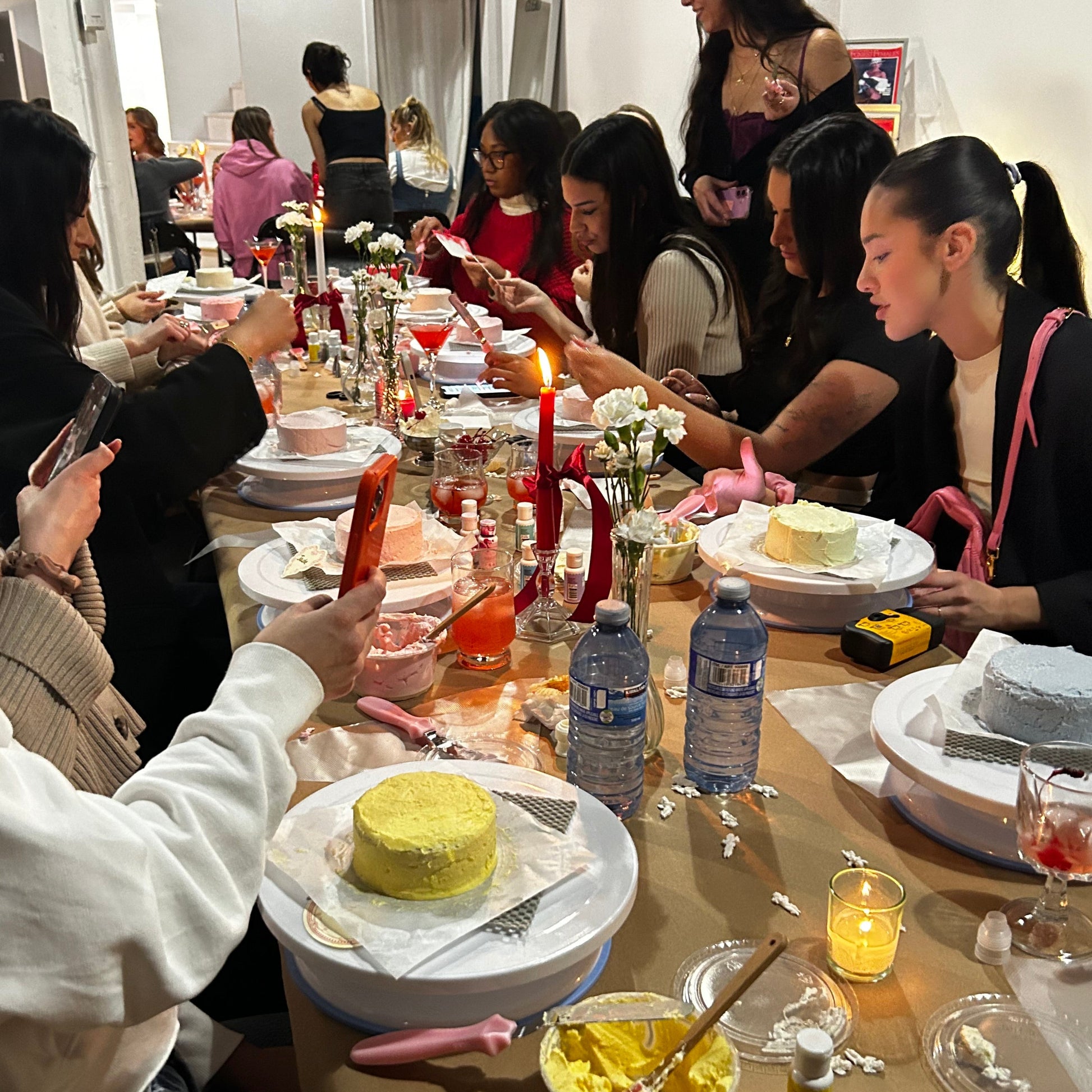 Close-up of guests piping onto a bento cake during a cake & sip event in Montreal