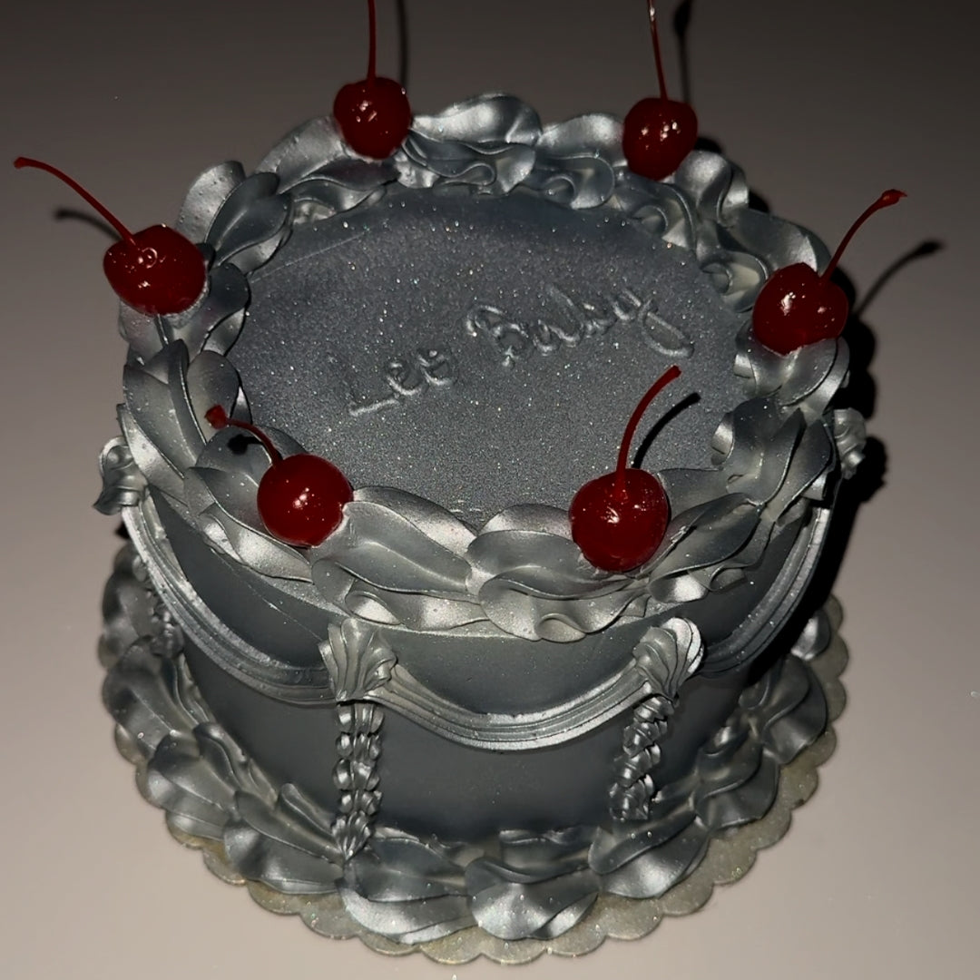 Vintage cake with metallic silver frosting, glitter, and cherries on top for a birthday in Montreal