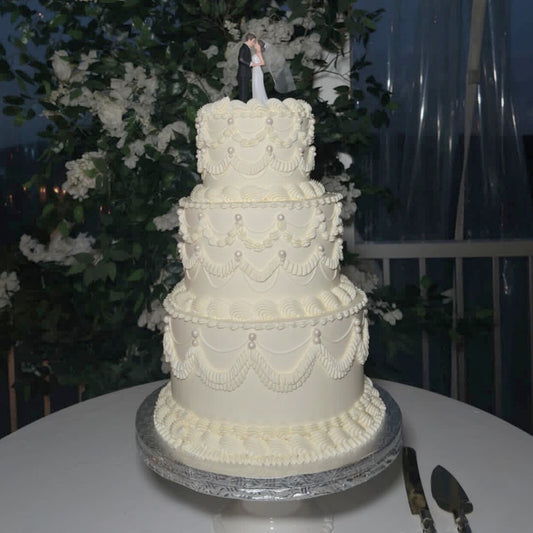 3 tier vintage wedding cake with classic piping, pearls, and a cake topper for a wedding in Montreal