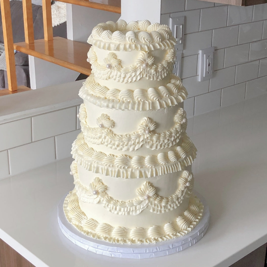 3 tier vintage wedding cake with classic piping, and pearls for a wedding in Montreal