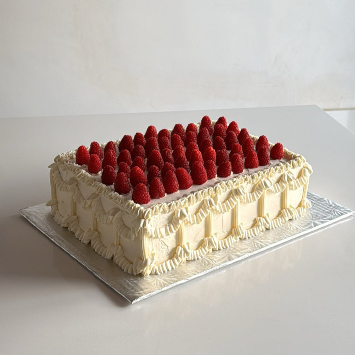 Vintage sheet cake with raspberries on top