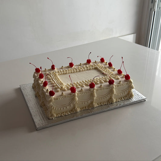 Vintage sheet cake with cherries on top